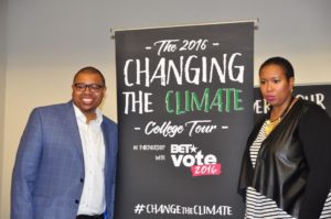 Founders of Vestige Strategies Quentin James and Stefanie Brown James stand Climate The Change Poster. (Photo by Jaylin Paschal) 